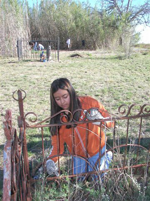 Lehman High School NHS President Diana Gomez works on up-close cleaning of the Francisco Coronado gravesite